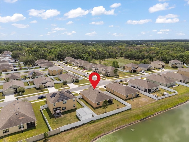 birds eye view of property with a view of trees, a residential view, and a water view