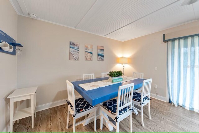 dining room featuring baseboards and wood finished floors