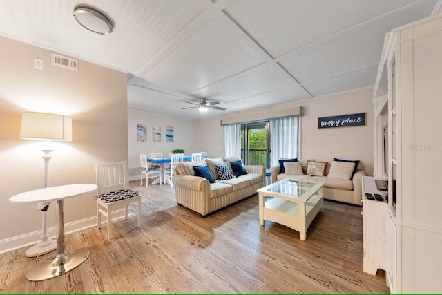 living room featuring ceiling fan, baseboards, light wood finished floors, and visible vents