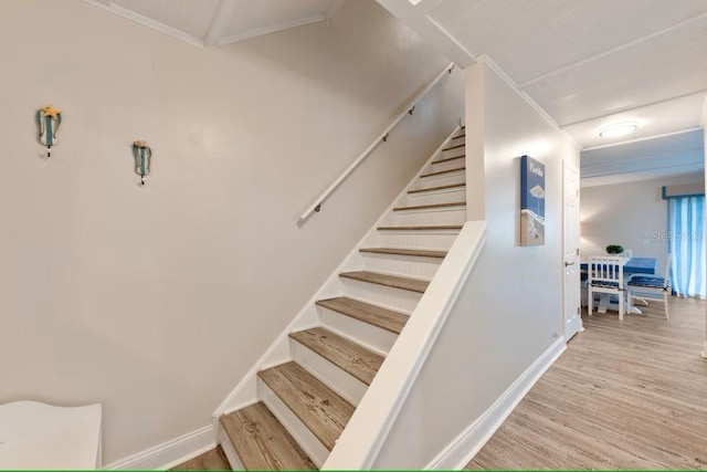 stairs with baseboards and wood finished floors