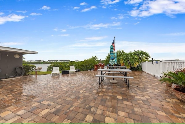 view of patio featuring outdoor dining area and fence