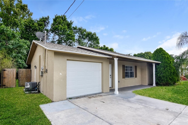 7338 Coventry Dr, Port Richey, FL 34668 - view of front facade with stucco siding, concrete driveway, an attached garage, and central AC unit