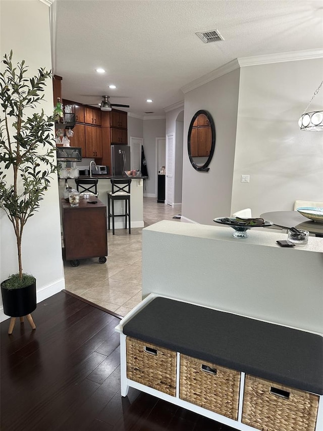 interior space featuring visible vents and a ceiling fan