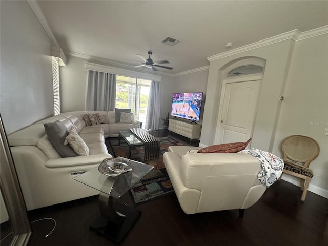 living room with ceiling fan, ornamental molding, visible vents, wood finished floors, and baseboards