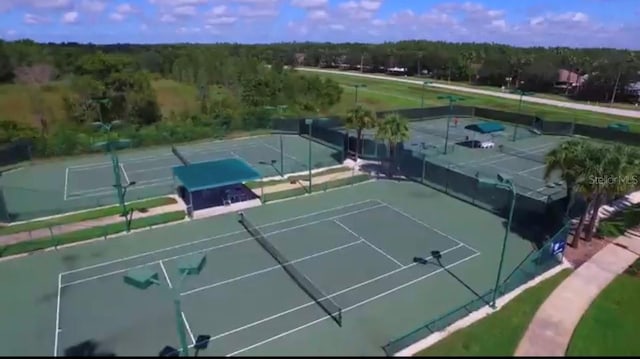 view of sport court featuring fence