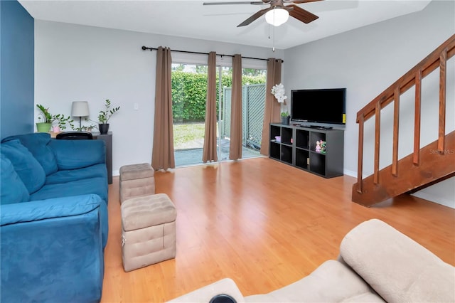 14053 Notreville Way, Tampa, FL 33624 - living room featuring wood finished floors, ceiling fan, and stairway