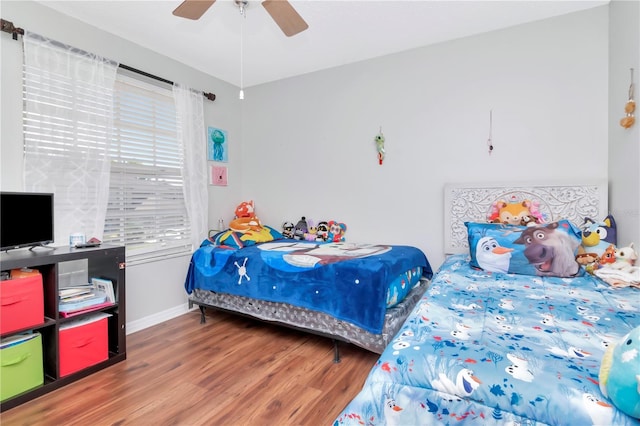 14053 Notreville Way, Tampa, FL 33624 - bedroom with baseboards, wood finished floors, and a ceiling fan