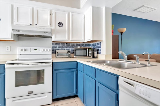 14053 Notreville Way, Tampa, FL 33624 - kitchen with visible vents, white appliances, blue cabinetry, under cabinet range hood, and a sink