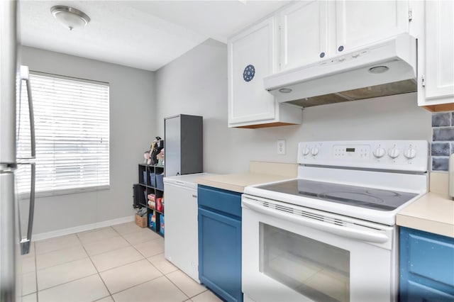 14053 Notreville Way, Tampa, FL 33624 - kitchen with under cabinet range hood, blue cabinetry, a healthy amount of sunlight, and electric range