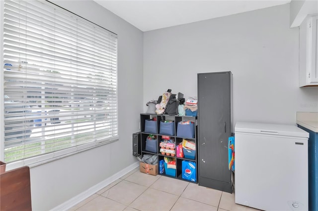 14053 Notreville Way, Tampa, FL 33624 - laundry area featuring baseboards and light tile patterned floors