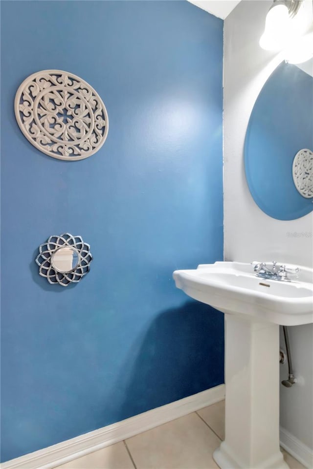14053 Notreville Way, Tampa, FL 33624 - bathroom with tile patterned floors, baseboards, and a sink