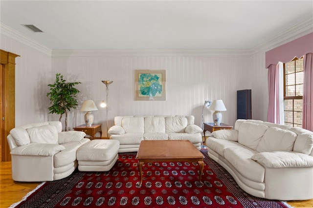living area featuring visible vents, wood finished floors, and ornamental molding