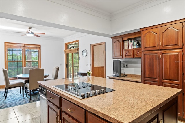 kitchen featuring ornamental molding, light tile patterned flooring, a ceiling fan, black electric cooktop, and a kitchen island