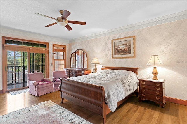 bedroom featuring wallpapered walls, baseboards, crown molding, hardwood / wood-style flooring, and access to exterior