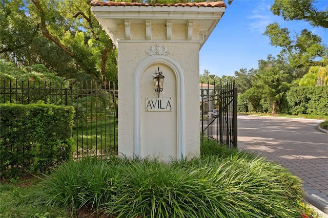 community sign with fence and a gate
