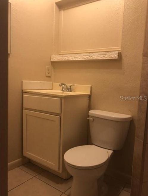1733 Grand Blvd, Holiday, FL 34690 - bathroom featuring toilet, tile patterned floors, and vanity