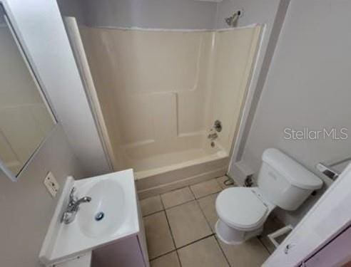 1733 Grand Blvd, Holiday, FL 34690 - bathroom featuring toilet, tile patterned floors, vanity, and washtub / shower combination
