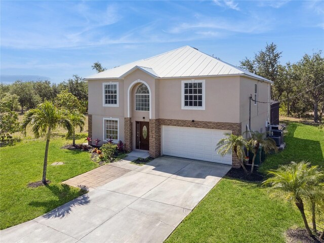 14319 Morristown Ave, Port Charlotte, FL 33981 - traditional-style house featuring stucco siding, a garage, concrete driveway, and stone siding