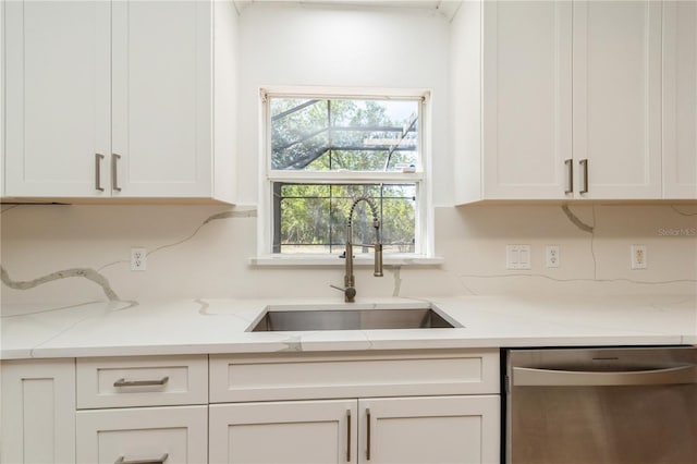 14319 Morristown Ave, Port Charlotte, FL 33981 - kitchen featuring dishwasher, a sink, white cabinetry, and decorative backsplash