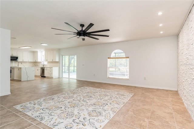 14319 Morristown Ave, Port Charlotte, FL 33981 - unfurnished living room with light tile patterned floors, ceiling fan, recessed lighting, a sink, and baseboards