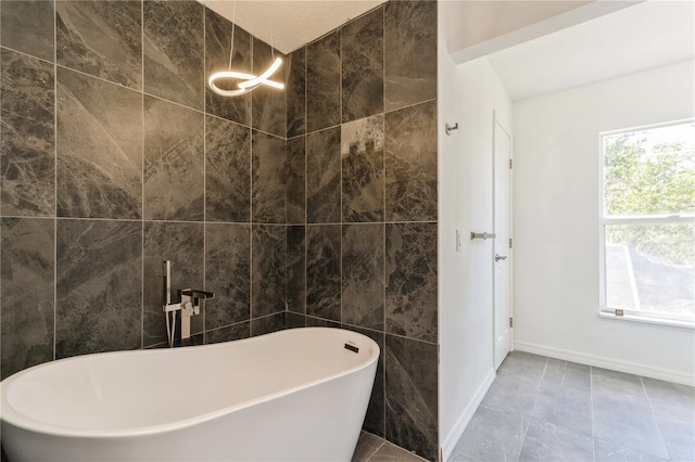 14319 Morristown Ave, Port Charlotte, FL 33981 - bathroom featuring a freestanding bath, baseboards, and tile walls