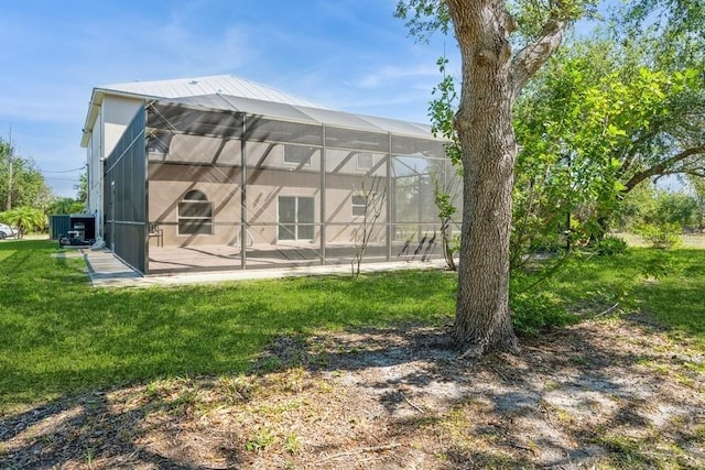 14319 Morristown Ave, Port Charlotte, FL 33981 - back of property with a patio area, a yard, and glass enclosure
