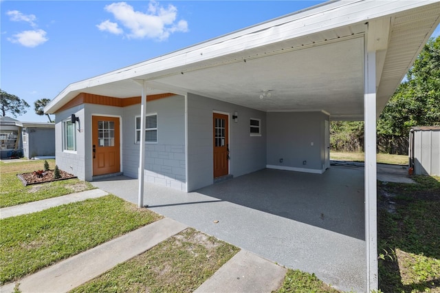 7139 Adare Dr, New Port Richey, FL 34653 - view of front of house featuring a front lawn, concrete block siding, and a carport