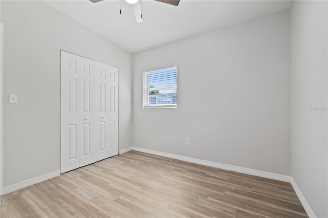 7139 Adare Dr, New Port Richey, FL 34653 - unfurnished bedroom featuring light wood-style flooring, a closet, baseboards, and ceiling fan