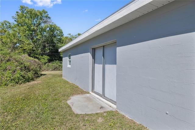 7139 Adare Dr, New Port Richey, FL 34653 - view of side of home with concrete block siding and a yard