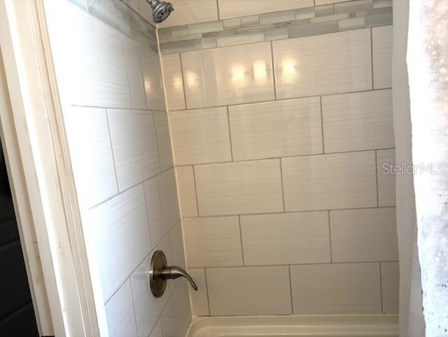 1408 San Juan Ct, Clearwater, FL 33756 - bathroom view of shower / bath combo with shower curtain