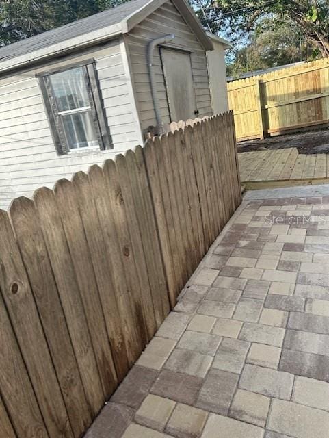 1408 San Juan Ct, Clearwater, FL 33756 - view of home's exterior featuring fence, a deck, an outdoor structure, and a patio area