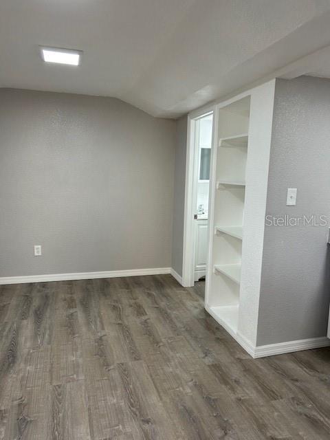 1408 San Juan Ct, Clearwater, FL 33756 - basement with dark wood finished floors and baseboards