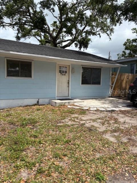 1408 San Juan Ct, Clearwater, FL 33756 - view of front of home featuring fence and a shingled roof