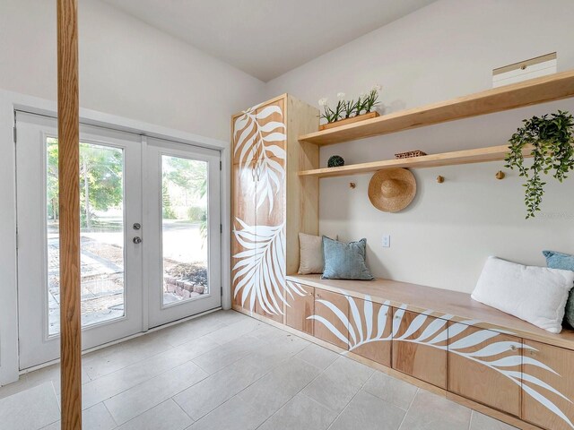 mudroom with light tile patterned flooring and french doors