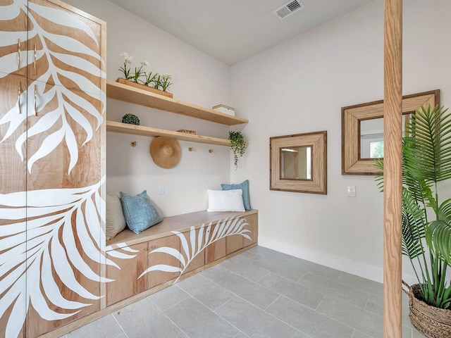 mudroom with tile patterned floors, baseboards, and visible vents
