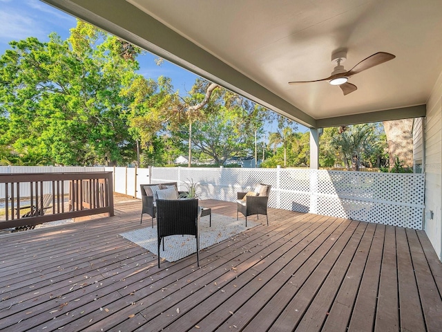deck featuring an outdoor hangout area, fence, and a ceiling fan