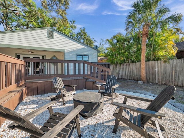 view of patio / terrace featuring a fire pit, fence, and a wooden deck