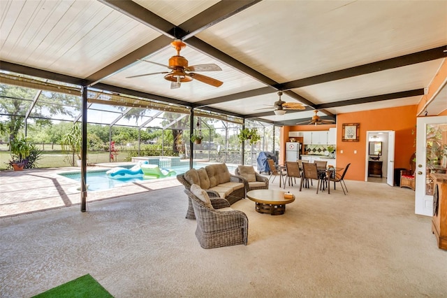 living room with a ceiling fan, carpet flooring, and beam ceiling
