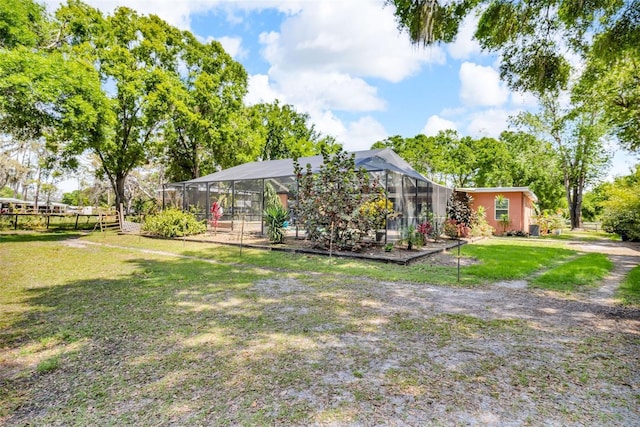exterior space featuring a lanai, a carport, and fence