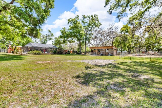 view of yard with a carport and fence
