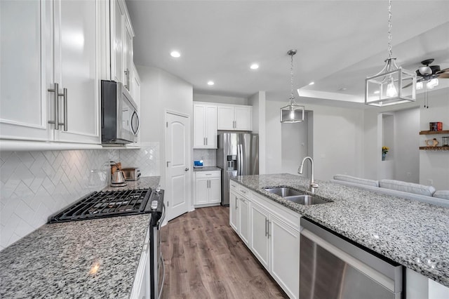 kitchen featuring a sink, white cabinetry, appliances with stainless steel finishes, dark wood-style floors, and recessed lighting