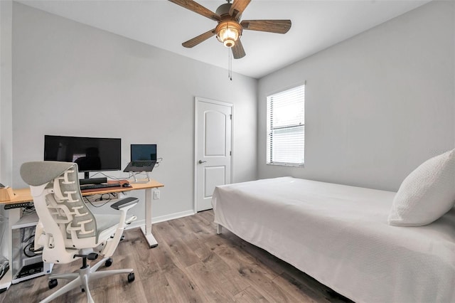 bedroom with baseboards, wood finished floors, and a ceiling fan