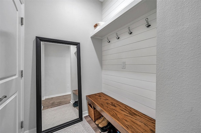 mudroom featuring baseboards and wood finished floors
