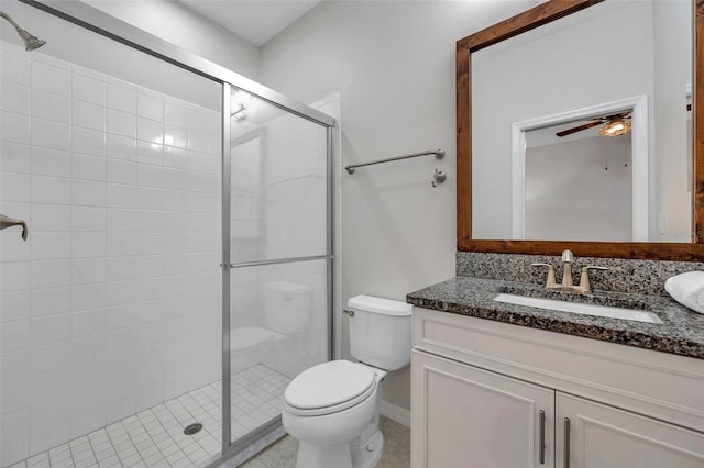 full bathroom with ceiling fan, toilet, a stall shower, and vanity