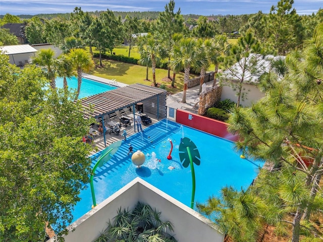 view of swimming pool featuring fence and a lawn