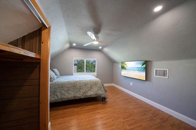 3986 Bennett Ln, Bonita Springs, FL 34134 - bedroom with vaulted ceiling, wood finished floors, a textured ceiling, baseboards, and visible vents