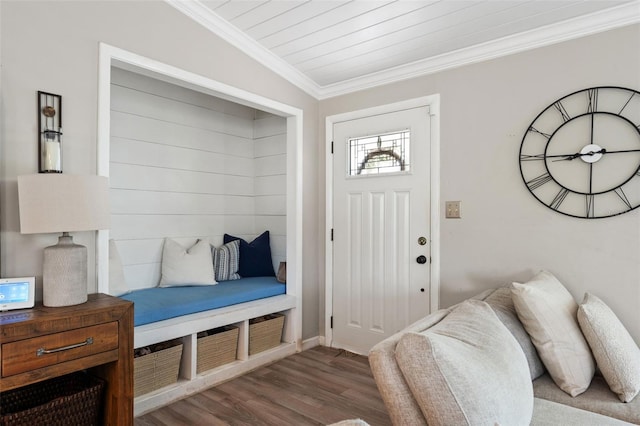 foyer entrance with ornamental molding and wood finished floors