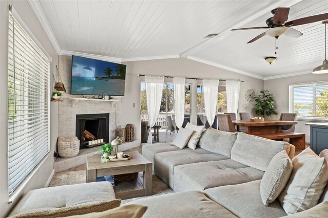 living room with wooden ceiling, a ceiling fan, ornamental molding, and vaulted ceiling