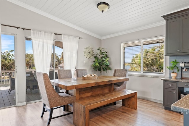 dining space with wooden ceiling, lofted ceiling, crown molding, and light wood-type flooring