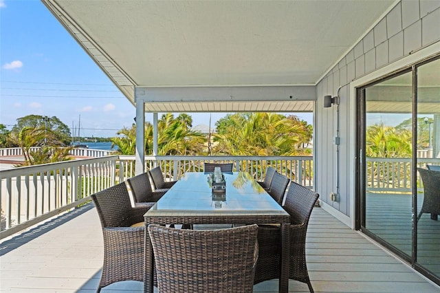 wooden terrace with outdoor dining area